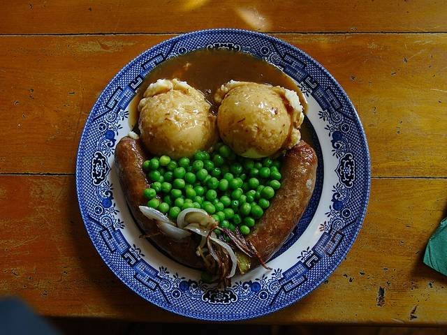 Ingredients and preparation for bangers and mash with onion gravy